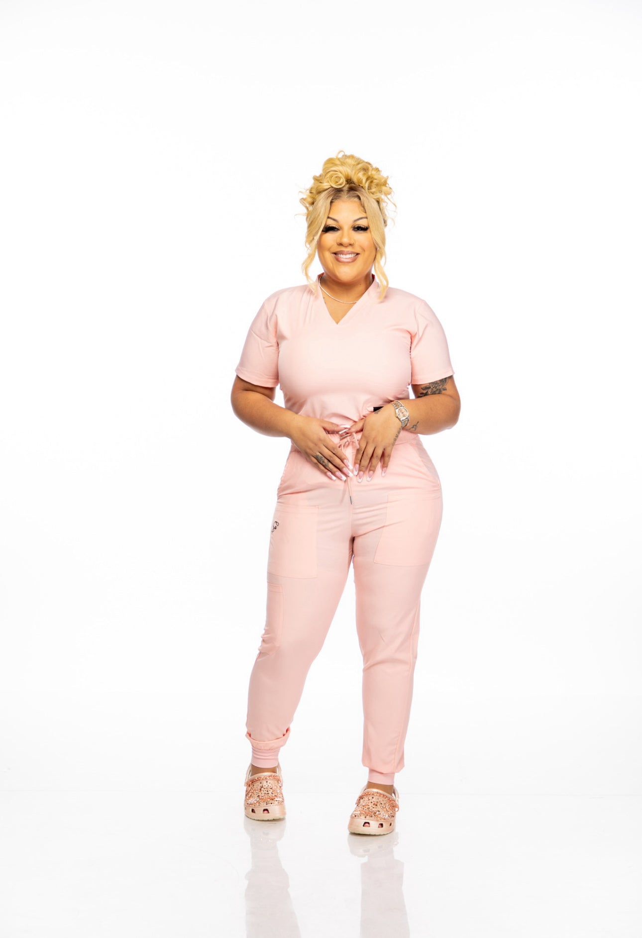 Person wearing a pink outfit on a white background